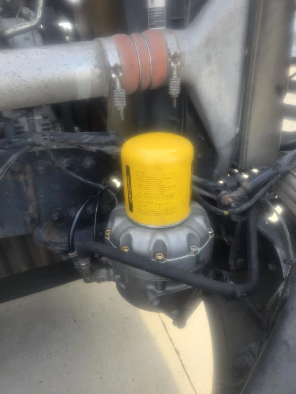 New yellow fuel filter mounted on a truck engine — Rickey Alexander Mobile Truck & Trailer Repair in Forrest City